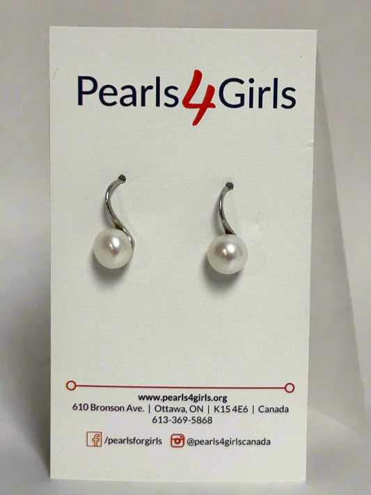 Side view of single white pearl drop earrings on a 'Pearls 4 Girls' branded card