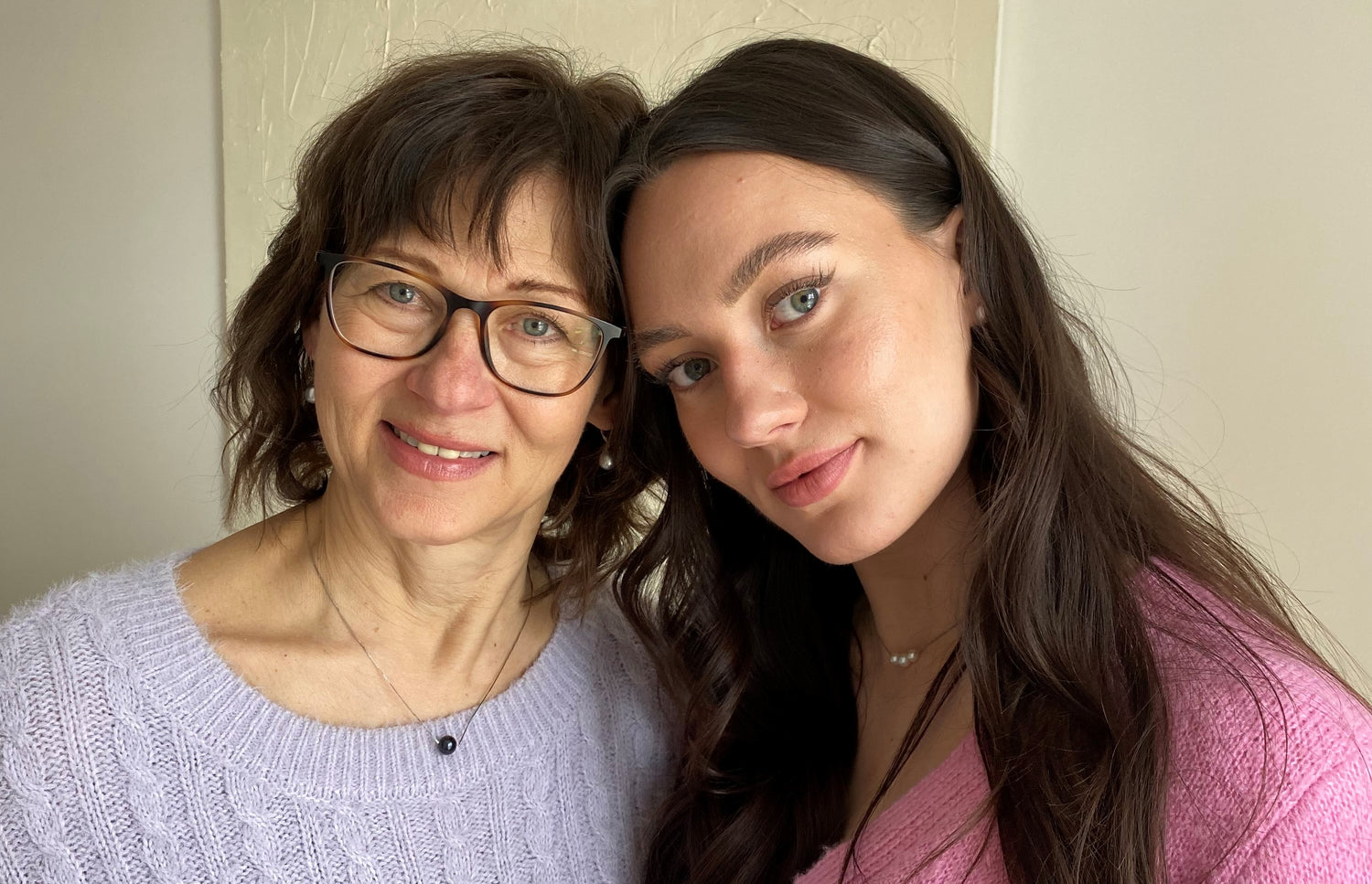 Mother and daughter photo celebrating Mother's Day wearing their pearl jewelry necklaces, earrings and rings.